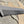 Load image into Gallery viewer, A steeltooth new standard comb with a deep red/brown finish on it on a rock.