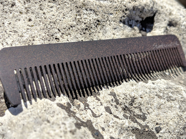 A steeltooth new standard comb with a deep red/brown finish on it. 