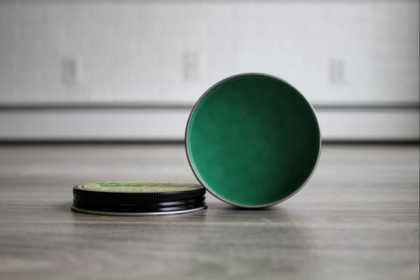 goon grease open can with texture and signature green pomade inside. 