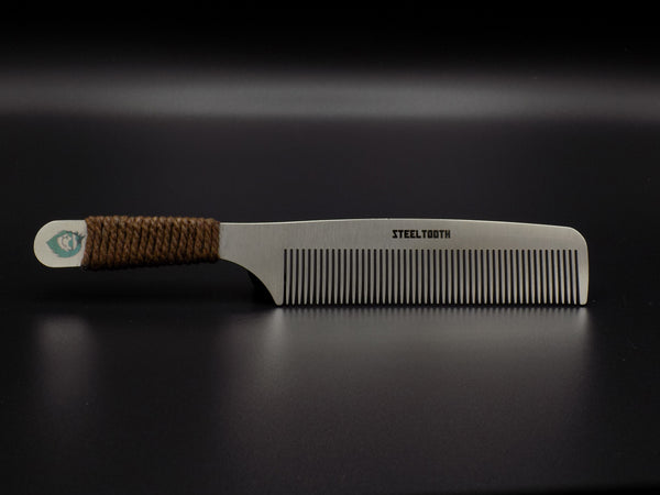 A steel comb with a handle made of cordage. A premium model of a comb designed for men. 
